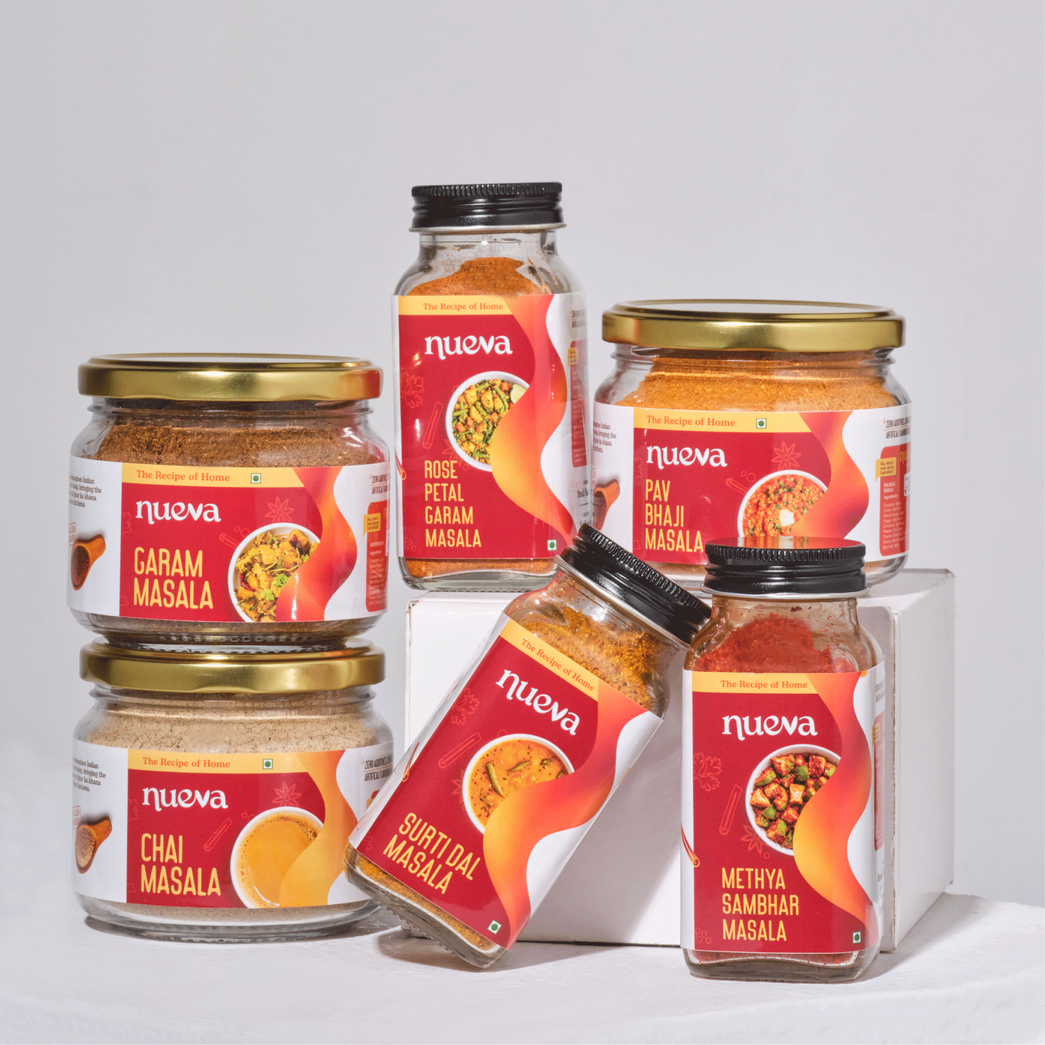Collection of jars with 'Nueva' spice labels on a white background